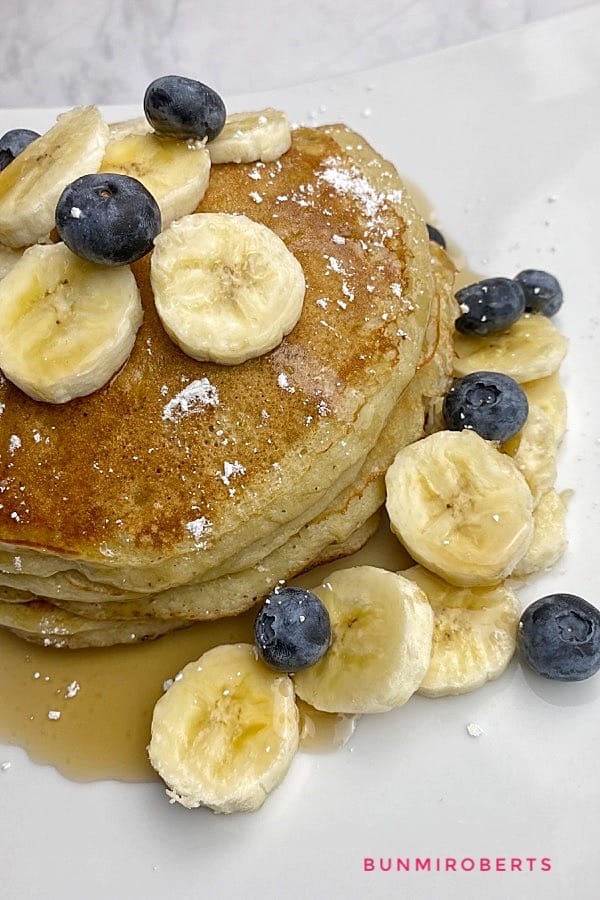 Banana pancake served with slice banana and blueberries