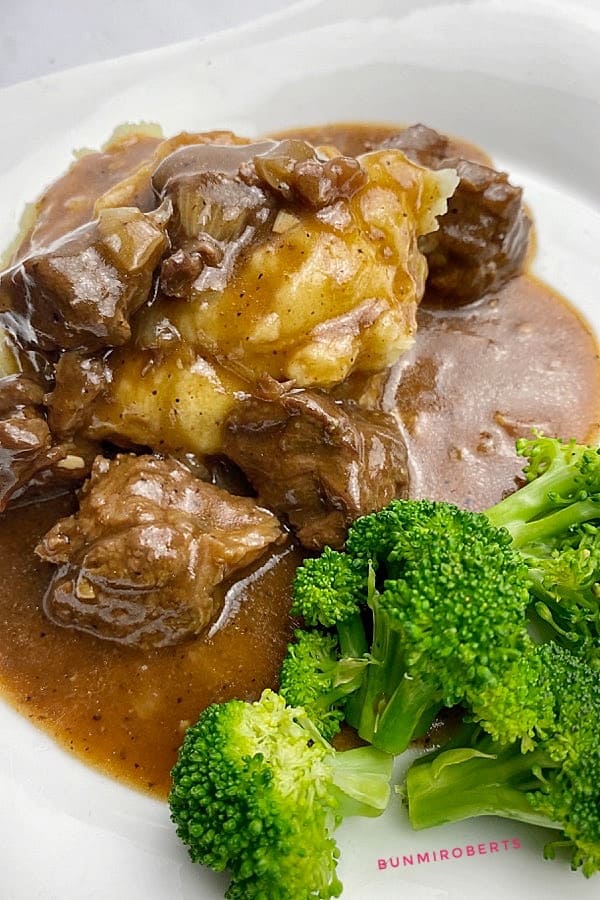 mashed potatoes, beef tips, gravy and steamed broccoli