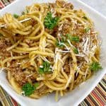 one pot spaghetti served with grated parmesan cheese and parsley