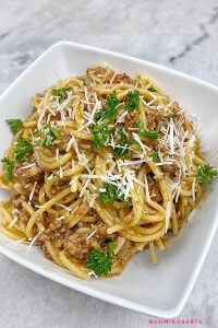 one pot spaghetti served with grated parmesan cheese and parsley